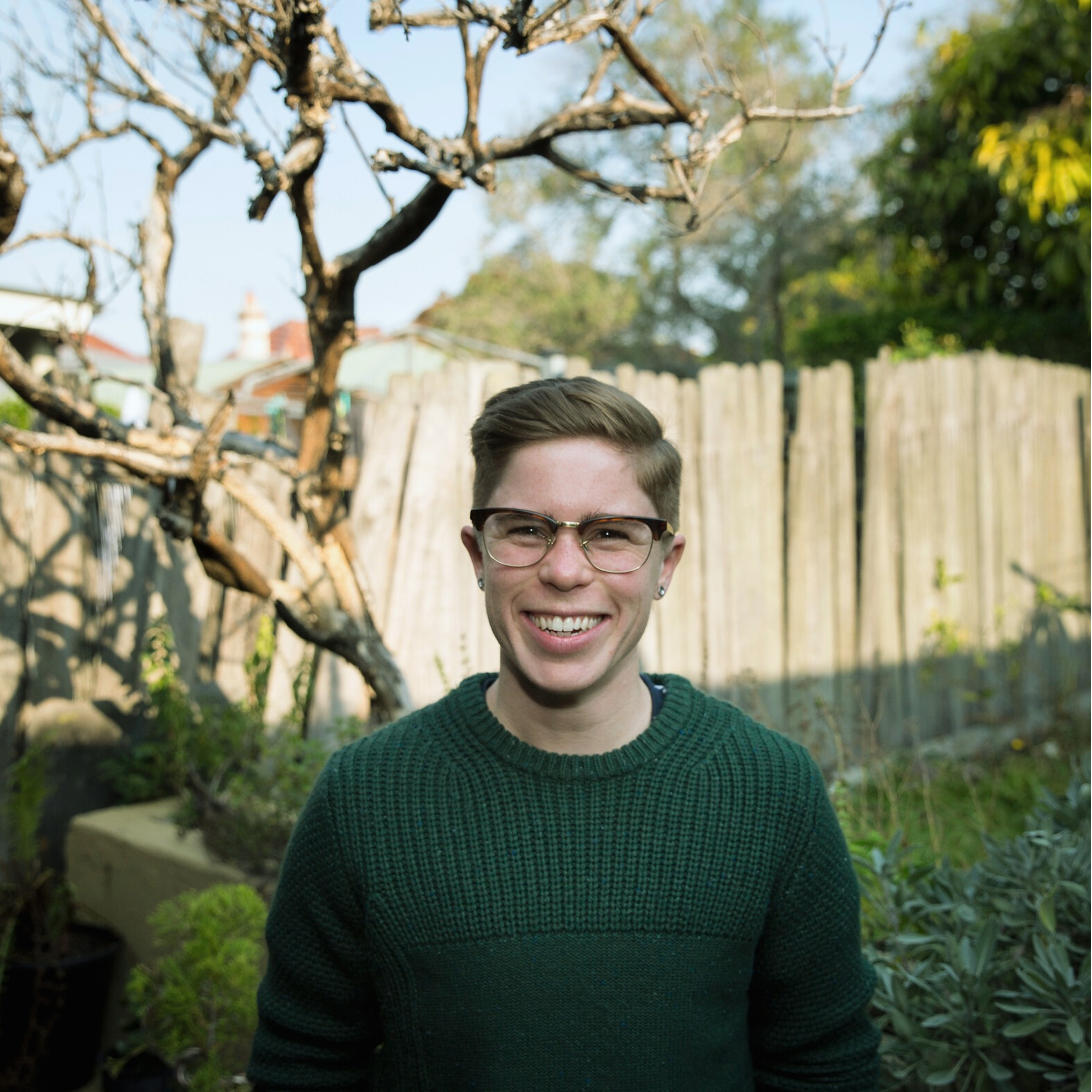 Katie wearing glasses and a green knitted jumper